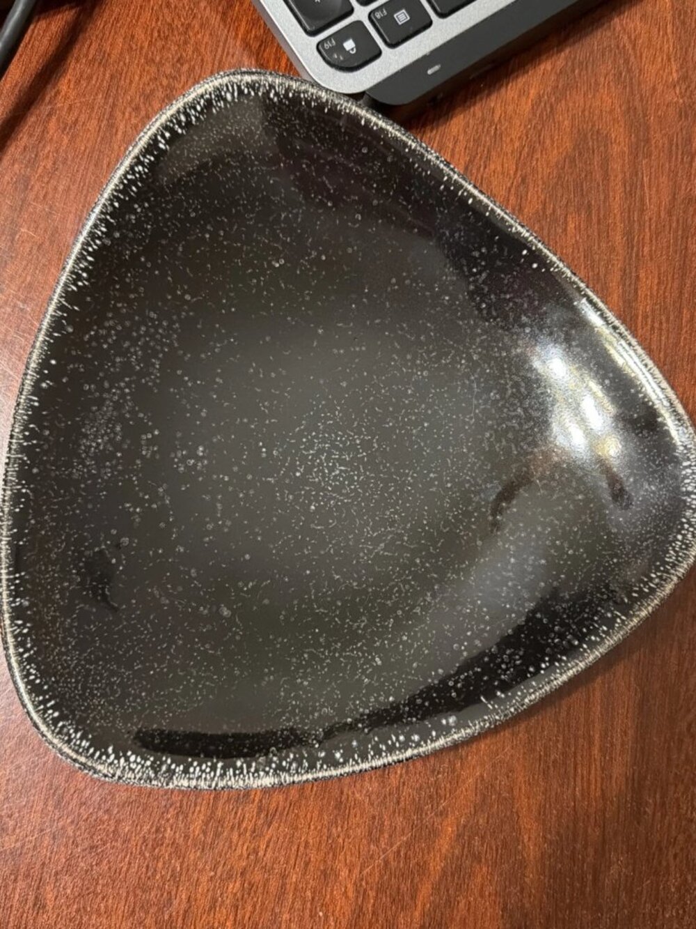 BIA Kitchen & Home Glazed Rounded Triangle Footed Plate In Black With Speckles